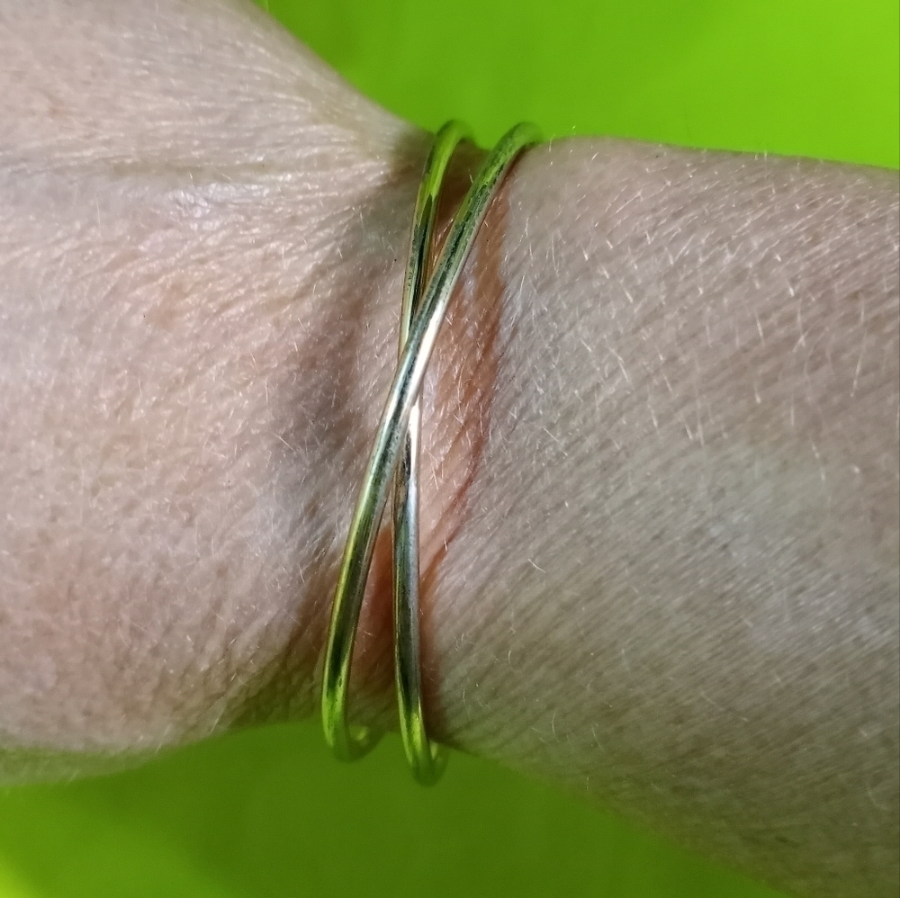 Goldtone wire crossed Cuff bracelet shows some wear